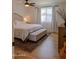 Bright bedroom with a large window, hardwood floors, and a comfortable bed with storage bench at 10609 N 32Nd Cir, Phoenix, AZ 85029