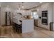 Bright kitchen featuring an island with counter seating, stainless appliances, and light wood flooring at 10609 N 32Nd Cir, Phoenix, AZ 85029