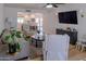 Bright living room features open layout to kitchen, wood floors, comfortable seating, and stylish furnishings at 10609 N 32Nd Cir, Phoenix, AZ 85029