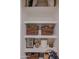Organized pantry featuring multiple shelves with baskets and storage jars at 10609 N 32Nd Cir, Phoenix, AZ 85029