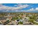 Extensive aerial view of a residential neighborhood with tree-lined streets, many houses, and partly cloudy skies with mountain views at 11025 N 45Th Ln, Glendale, AZ 85304