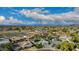 Expansive aerial view of a residential neighborhood with mature trees, many houses, and partly cloudy skies with mountain views at 11025 N 45Th Ln, Glendale, AZ 85304