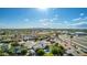 Wide aerial view of a residential neighborhood with tree-lined streets, many houses, and mountain views in the distance at 11025 N 45Th Ln, Glendale, AZ 85304