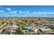 Expansive aerial view of a residential neighborhood with mature trees, many houses, and clear skies with mountain views at 11025 N 45Th Ln, Glendale, AZ 85304