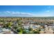 Expansive aerial view of a residential neighborhood with mature trees, many houses, and clear skies with mountain views at 11025 N 45Th Ln, Glendale, AZ 85304