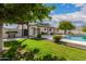 Sprawling backyard featuring a refreshing pool, lush green lawn, and a private outdoor grilling area at 11025 N 45Th Ln, Glendale, AZ 85304