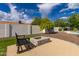 Backyard view featuring a modern fire pit, a seating area, and established trees at 11025 N 45Th Ln, Glendale, AZ 85304