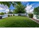 Lush backyard featuring green grass, mature shade trees, and well-manicured landscape design at 11025 N 45Th Ln, Glendale, AZ 85304