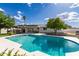 Beautiful backyard with a large pool, covered patio, and well-manicured landscaping at 11025 N 45Th Ln, Glendale, AZ 85304