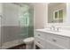 Bathroom featuring a glass-enclosed shower and a vanity sink with white cabinets at 11025 N 45Th Ln, Glendale, AZ 85304