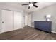 Bedroom features tile floors, closet, ceiling fan, gray walls, and modern furnishings at 11025 N 45Th Ln, Glendale, AZ 85304