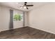 Inviting bedroom with modern tile flooring, a ceiling fan, and a window for natural light, creating a serene atmosphere at 11025 N 45Th Ln, Glendale, AZ 85304