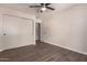 Bedroom features tile floors, closet, ceiling fan, and neutral walls offering space with comfort and functionality at 11025 N 45Th Ln, Glendale, AZ 85304