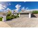 Garage and driveway showing manicured shrubs and walkway at 11025 N 45Th Ln, Glendale, AZ 85304