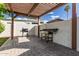Outdoor kitchen area with pavers, a grill, and a pergola at 11025 N 45Th Ln, Glendale, AZ 85304