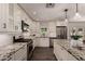 Modern kitchen featuring stainless steel appliances, granite countertops, white cabinets, and long center island with seating at 11025 N 45Th Ln, Glendale, AZ 85304