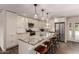 Bright kitchen with stainless steel appliances, granite countertops and long center island with bar stool seating at 11025 N 45Th Ln, Glendale, AZ 85304