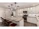 Remodeled kitchen features granite countertops, ample white cabinetry, stainless steel appliances, and a large island at 11025 N 45Th Ln, Glendale, AZ 85304