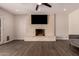 Cozy living room featuring a painted brick fireplace and hardwood floors at 11025 N 45Th Ln, Glendale, AZ 85304