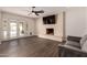 Cozy living room featuring a brick fireplace, a ceiling fan, and glass doors leading to the outdoor area at 11025 N 45Th Ln, Glendale, AZ 85304
