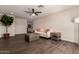 Bright living room with dark hardwood flooring, a ceiling fan, neutral walls and comfortable seating at 11025 N 45Th Ln, Glendale, AZ 85304