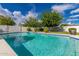 Inviting swimming pool with blue trim, surrounded by a patio, and lush landscaping at 11025 N 45Th Ln, Glendale, AZ 85304