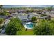 Aerial view of home featuring a private pool, covered patio, grassy yard, mature trees, and an outdoor lounge area at 11025 N 45Th Ln, Glendale, AZ 85304