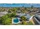 Aerial view of home featuring a private pool, covered patio, grassy yard, mature trees, and an outdoor lounge area at 11025 N 45Th Ln, Glendale, AZ 85304