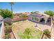Spacious backyard features a well-manicured lawn, brick patio, shed, mature trees, and an inviting basketball hoop area at 1144 E Elm Rd, San Tan Valley, AZ 85140