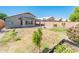This expansive backyard offers a lush lawn, brick patio, shed, mature trees, and a fun basketball area for outdoor enjoyment at 1144 E Elm Rd, San Tan Valley, AZ 85140