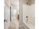 Bathroom and hall features tiled floors, tub shower, and hallway with a white door at 1144 E Elm Rd, San Tan Valley, AZ 85140