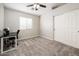 Bedroom with a ceiling fan, desk, and sliding door closet, offering a comfortable living space at 1144 E Elm Rd, San Tan Valley, AZ 85140