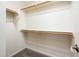 Walk-in closet features neutral carpet, white walls, and wood racks for organization at 1144 E Elm Rd, San Tan Valley, AZ 85140