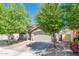 Charming single-story home featuring a well-maintained front yard with mature trees and a two-car garage at 1144 E Elm Rd, San Tan Valley, AZ 85140