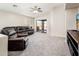 Spacious living room boasting vaulted ceilings, plush carpet, and sliding door access to the backyard at 1144 E Elm Rd, San Tan Valley, AZ 85140
