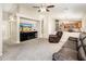 Welcoming living room showcasing plush carpet, modern furniture, and seamless access to the kitchen at 1144 E Elm Rd, San Tan Valley, AZ 85140