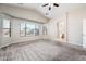Bright main bedroom with vaulted ceilings, plush carpet, and large windows with backyard views at 1144 E Elm Rd, San Tan Valley, AZ 85140