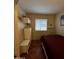 This cozy bedroom has a maroon comforter, ample storage, and natural light at 12123 W Bell Rd # 337, Surprise, AZ 85378