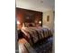 Comfortable bedroom showcasing a queen-sized bed with striped bedding and tile floor at 12123 W Bell Rd # 337, Surprise, AZ 85378