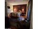 Cozy bedroom featuring a queen-sized bed with striped bedding and tile floor at 12123 W Bell Rd # 337, Surprise, AZ 85378
