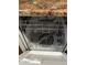 A view inside an empty stainless steel Frigidaire dishwasher showing rack configuration at 12123 W Bell Rd # 337, Surprise, AZ 85378