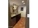 A kitchen showcasing a stainless steel sink, dishwasher, dark wood cabinets and stylish counter tops at 12123 W Bell Rd # 337, Surprise, AZ 85378
