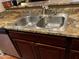 A kitchen sink with a double basin and stainless steel fixtures, set in stylish counter tops at 12123 W Bell Rd # 337, Surprise, AZ 85378