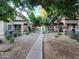 Beautifully landscaped courtyard surrounded by mature shade trees and flowering plants for a peaceful setting at 125 S 56Th St # 75, Mesa, AZ 85206
