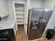 Modern kitchen boasting stainless steel refrigerator and a walk-in pantry for ample storage at 125 S 56Th St # 75, Mesa, AZ 85206