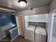 Upstairs laundry area with washer, dryer and storage shelves at 125 S 56Th St # 75, Mesa, AZ 85206