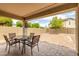 Inviting covered patio and backyard featuring brick pavers, perfect for outdoor dining and relaxing at 14205 N 136Th Ln, Surprise, AZ 85379