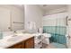 Bathroom with hardwood vanity, standard toilet, and shower with curtain at 14205 N 136Th Ln, Surprise, AZ 85379
