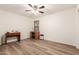 Bedroom with ceiling fan and hardwood flooring at 14205 N 136Th Ln, Surprise, AZ 85379