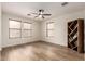 Bedroom with hardwood flooring, a ceiling fan, and bookcase at 14205 N 136Th Ln, Surprise, AZ 85379